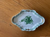 Top view of Herend Chinese Bouquet Green dish showing floral motif and scalloped gold-trim border