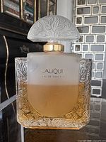 Front view of Lalique bottle showing leaf design, label, fill level
