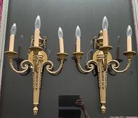 Both matching brass wall sconces front view