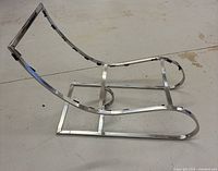 Profile view of polished metal chaise lounge frame