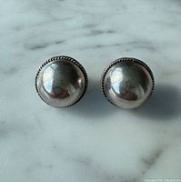 front view of both dome earrings on marble surface