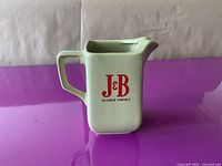Front view of ceramic J&B Scotch Whisky pitcher