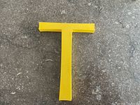 Front view of yellow plastic letter T
