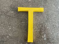 Front view of yellow plastic letter T