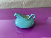 Side view showing overall shape, spout, handle and glaze finish
