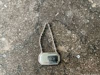 front of sterling SCOTCH tag on stone background