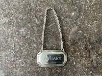 Front view showing engraving and chain