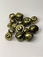 Cluster of mixed brass jingle bells showing quantity and sizes
