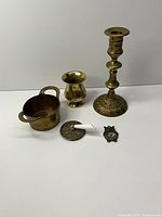Group shot of all five brass items on white background