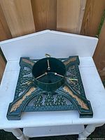 Top view of cast iron Christmas tree stand on white table