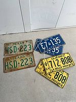 All six license plates arranged on floor