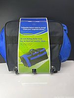 Front of packaged 36-inch rolling duffel trunk showing size and wheels