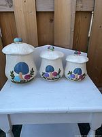 Front view of three Arnels mushroom canisters