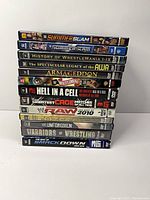 Stack of 11 WWE DVD spines