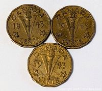 Three 1943 Canadian five cent coins, full view