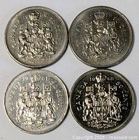 Four Canadian fifty-cent coins, dates visible