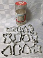 all cookie cutters arranged to show each shape plus container