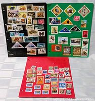 Three album pages filled with worldwide stamps