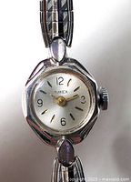 Close-up of Timex watch dial, octagonal case, crown visible