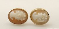 Front view of both oval shell cameo earrings