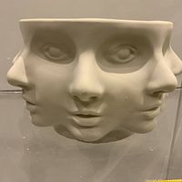 Front view of ceramic bowl with abstract faces