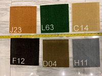 All six carpet trivets laid out with measuring tape for size reference