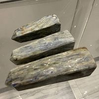 Three polished iridescent stone towers side view