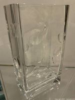 Front view showing concave bubble impressions and thick clear glass walls