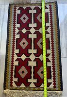 Full view of rug with measuring tape showing length