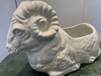 Left-front view of white ceramic ram planter