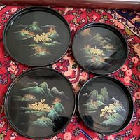 Four trays spread out showing painted landscapes and size differences