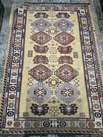 Full view of entire rug showing design, colors and wear