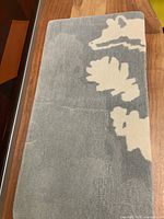 Full view of grey and cream wool mat