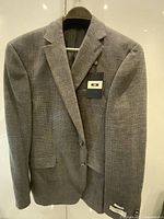 Front view of grey Joseph Abboud blazer with tags attached
