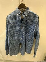 Front view of Nautica blue check shirt with tags attached on hanger