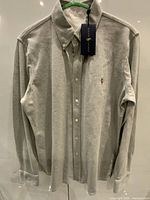 Front view of heather grey Ralph Lauren button-down shirt hanging, showing overall condition and logo