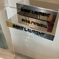 Both Saint Laurent mirrored blocks together showing size difference and logo cutout
