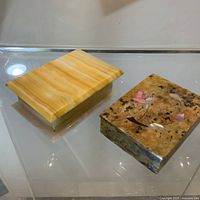 Both marble boxes closed, showing exterior finishes