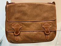 Front view of brown pebble-grain leather messenger bag