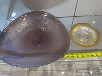 Large and small dishes beside measuring tape