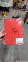 Close-up of a sealed red Air Canada Rouge iPad cover