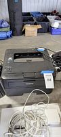 Full view of Brother laser printer showing overall condition and attached power cord