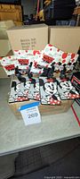 Front view showing multiple packaged Mickey Mouse plastic tags on box