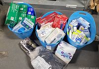 Three blue bins with gloves, masks, creams and respirator