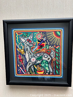 Front view of framed Huichol yarn art showing doe and surrounding motifs