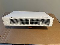 Front view showing white louvered grille and overall exterior