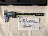 Caliper showing jaws, scale, display and small manual sheet