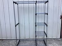 Full view of assembled metal closet shelf system showing frame, shelves and hanging area