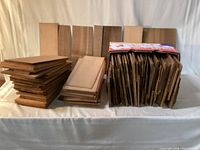 Stacked cedar shingles and boxed shingles on table