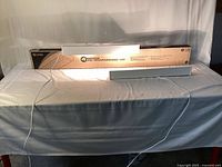 Boxed 4' LED wraparound fixture with two smaller fixtures in front